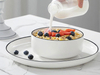 Juego de vajilla minimalista de porcelana blanca y cerámica con borde negro